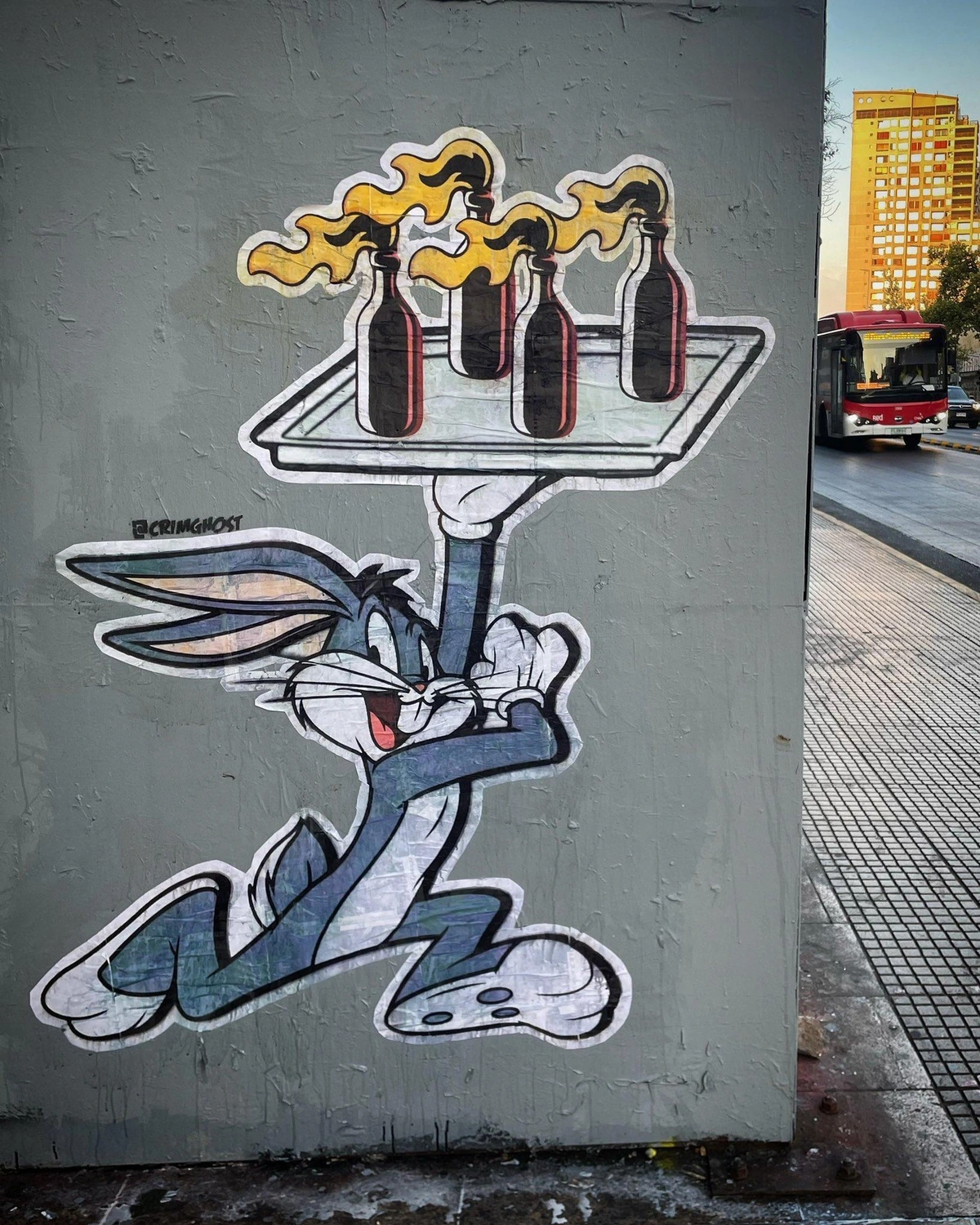 graffiti on a wall of Bugs Bunny serving up a platter full of Molotov cocktails